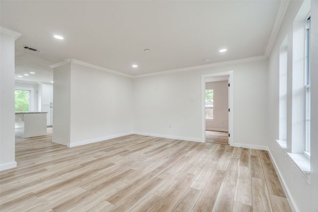 Spare room featuring light wood-style flooring, ornamental molding, and recessed lighting | Image 9
