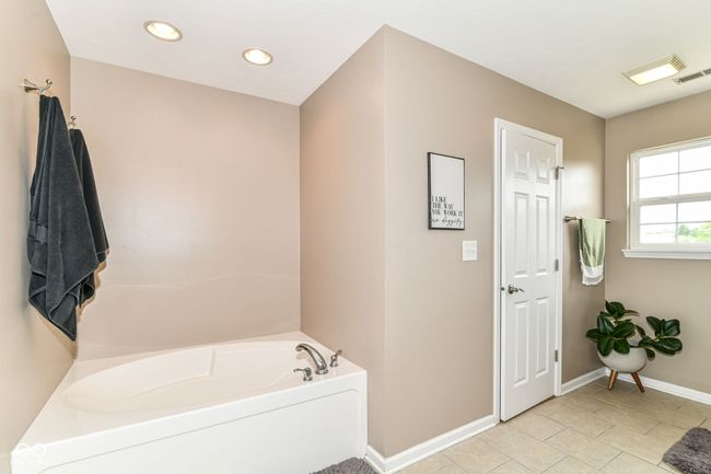 full bath featuring a garden tub, baseboards, tile patterned floors, and recessed lighting | Image 17