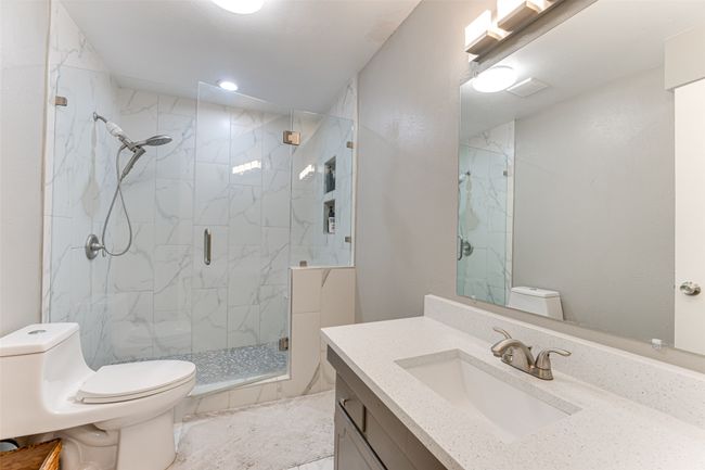 Full bath featuring toilet, a marble finish shower, vanity, and recessed lighting | Image 16