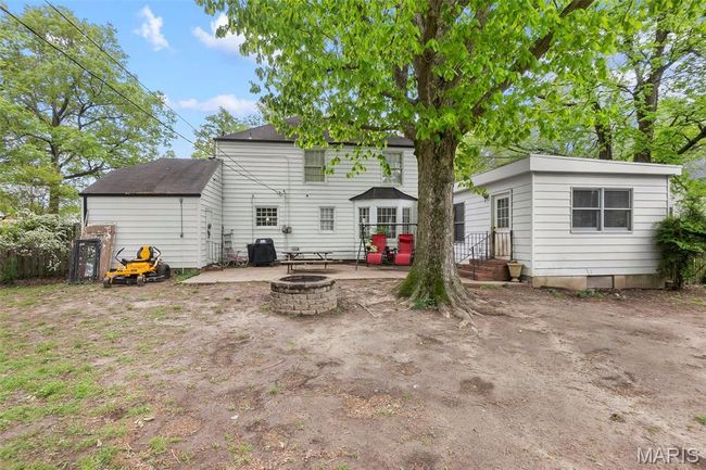 Rear view of house featuring a patio and an outdoor fire pit | Image 17