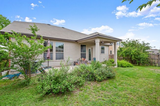 Rear view of house featuring a ceiling fan, fence, and a yard | Image 31