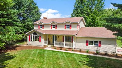 View of front of house with covered porch and a front lawn | Image 1