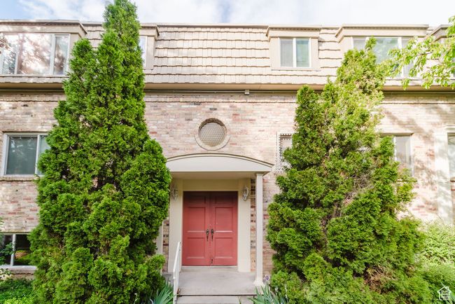 Entrance to property with mansard roof and brick siding | Image 19