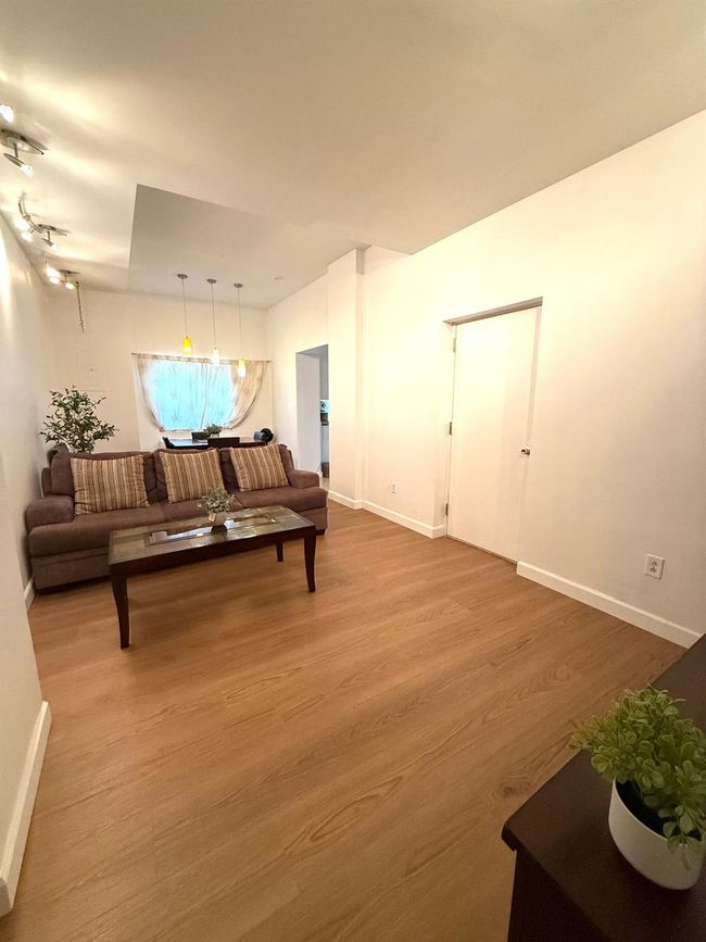 Living area with baseboards and wood finished floors | Image 7