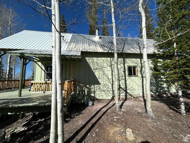 View of side of property with a wooden deck and a metal roof | Image 37