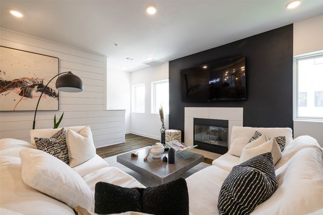 Living room featuring a fireplace, an accent wall, visible vents, recessed lighting, and wood finished floors | Image 12