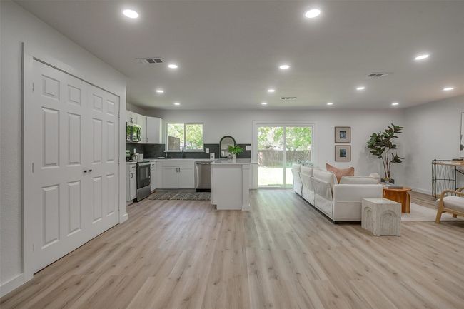 Living room with light wood-style flooring and recessed lighting | Image 8