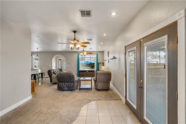 Living room featuring french doors, ceiling fan, plenty of natural light, and light carpet | Image 22