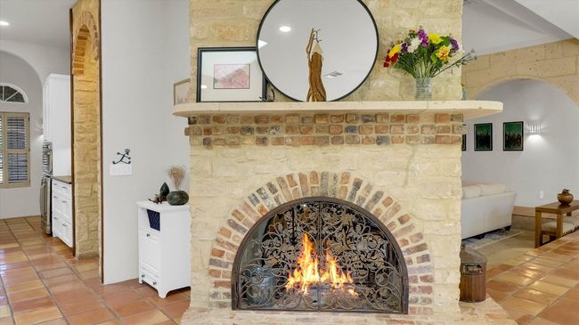 There are Four cstom stone and Brick fireplaces, three have a gas log lighter and this one is see through between the dining area and family room | Image 21