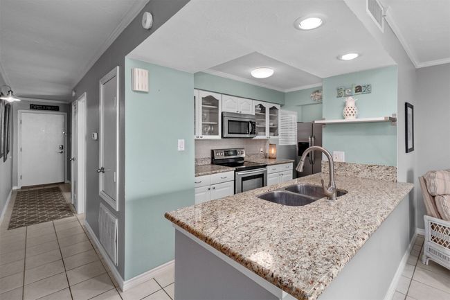 Open floor plan with recessed lights and area for barstools | Image 9