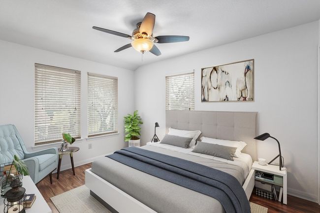 Bedroom with baseboards, ceiling fan, and wood finished floors | Image 16