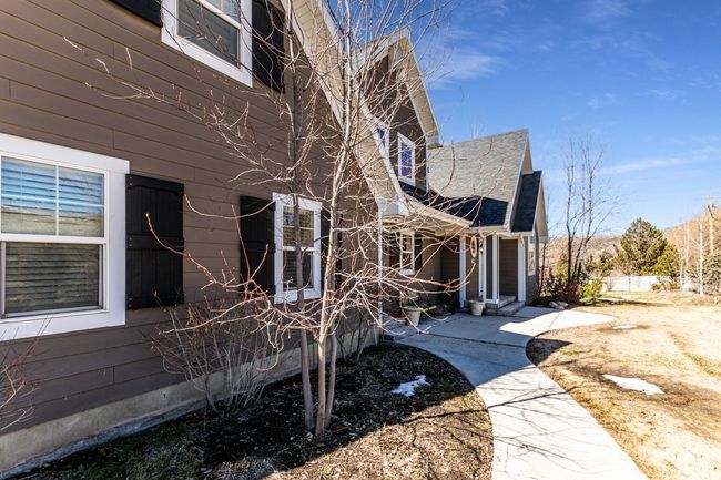 View of property exterior featuring a shingled roof | Image 53