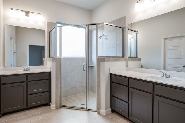 Bathroom with tile patterned flooring, vanity, and walk in shower | Image 17