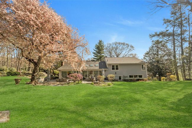 Backyard with a patio area and a beautiful landscaping | Image 15