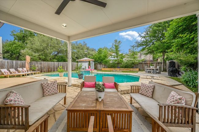 Fenced backyard with outdoor lounge area, a patio area, and ceiling fan | Image 26