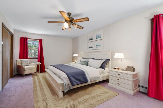 Virtually staged Primary bedroom with windows, closet, and full ensuite bathroom | Image 12