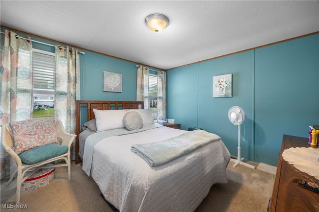 Bedroom with carpet floors and ornamental molding | Image 29