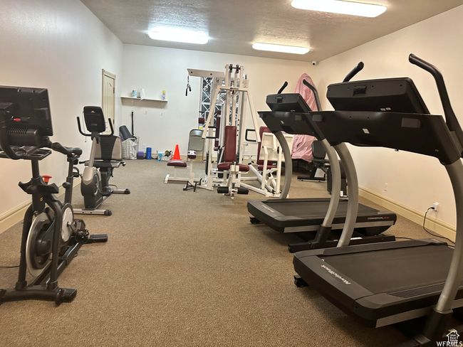 Exercise room with a textured ceiling | Image 39