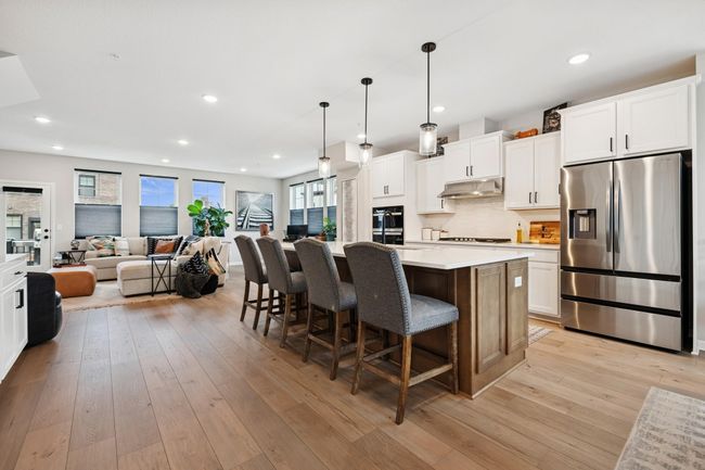 ChatGPT said: Open-concept chef’s kitchen with a spacious breakfast bar—ideal for entertaining and casual gatherings. | Image 22
