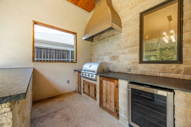 View of patio / terrace with beverage cooler and exterior kitchen | Image 13