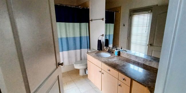 Ensuite Bathroom tile patterned floors and Lit Vanity with Sink | Image 36