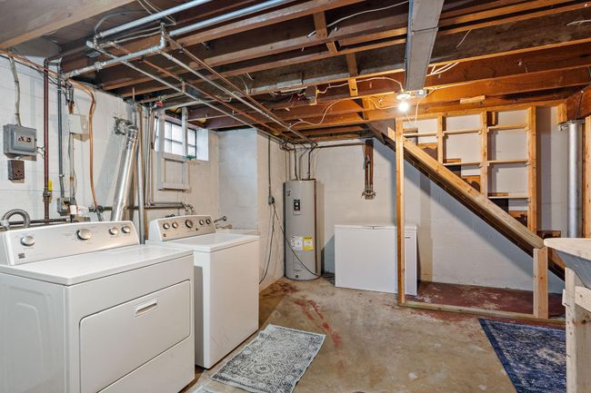 The laundry area showing the stairs leading to the main floor. | Image 19