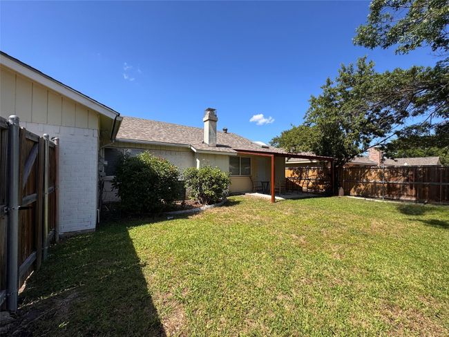 View of fenced backyard | Image 19