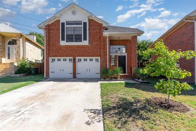 View of property with a front lawn and a garage | Image 3