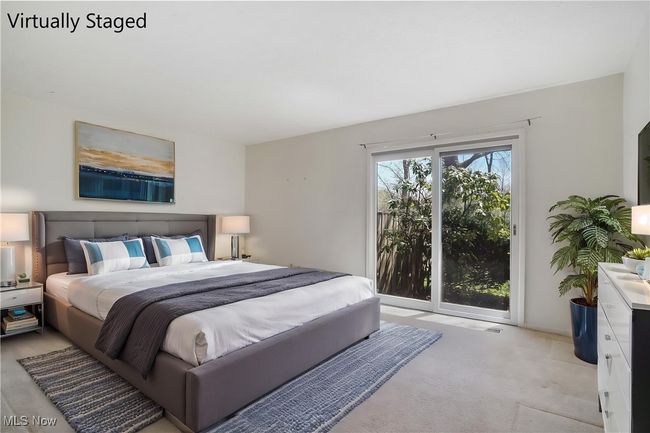 Bedroom featuring light colored carpet and access to exterior | Image 27