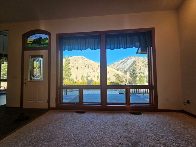 Please note the stain glass window over the door and the excellent view of the Sapphires out of the oversized windows in the living area | Image 9
