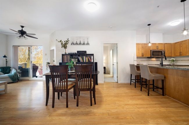 Dining space featuring a ceiling fan, baseboards, and light wood-style floors | Image 10