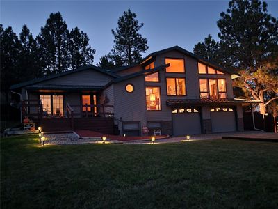 View of front of home with a yard, a garage, and a deck | Image 3