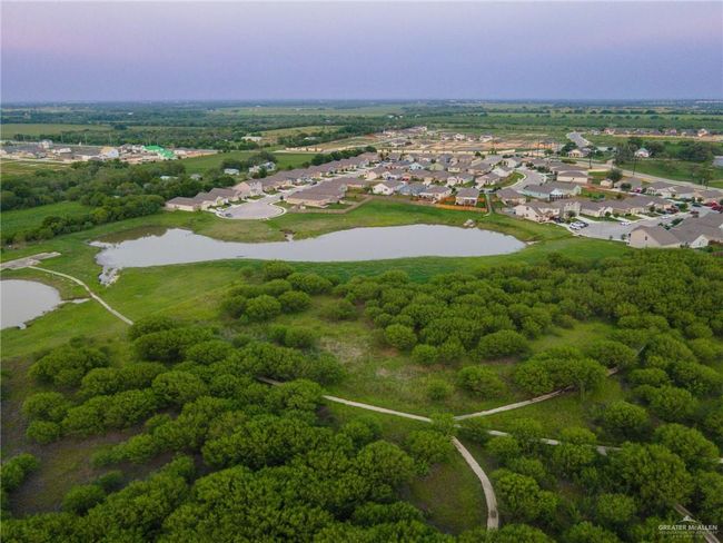 Aerial view of property and surrounding area featuring a large body of water and nearby suburban area | Image 40
