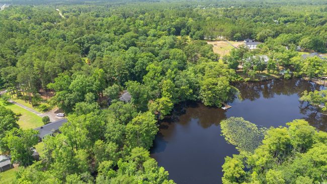 Aerial view of property and surrounding area featuring a large body of water and a heavily wooded area | Image 38