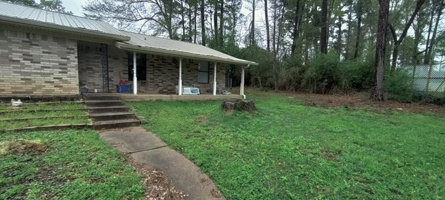 View of exterior entry with a porch and a metal roof | Image 4