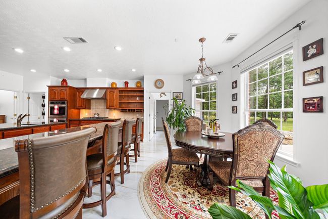 Cozy dining area next to the kitchen with large windows | Image 12