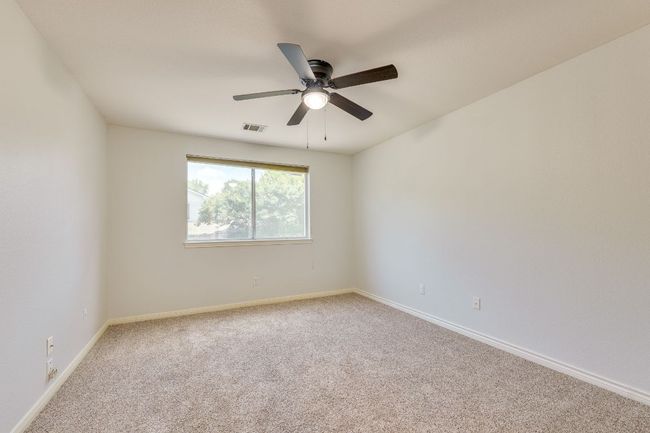 Carpeted spare room featuring ceiling fan and baseboards | Image 22