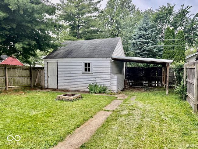 view of shed featuring a fenced backyard and a carport | Image 5