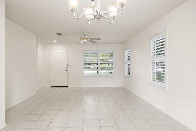 Entryway/ Livingroom with a chandelier, a ceiling fan, and recessed lighting | Image 18