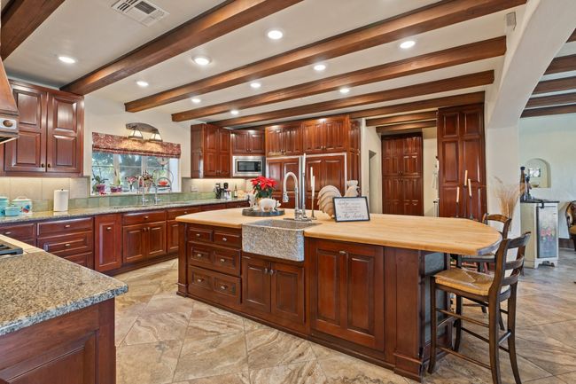 Kitchen featuring visible vents, recessed lighting, stainless steel microwave, a sink, and beam ceiling | Image 9