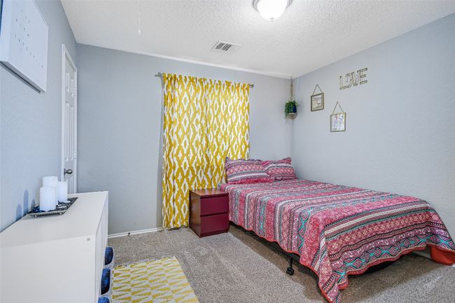 Bedroom featuring carpet floors and a textured ceiling | Image 17