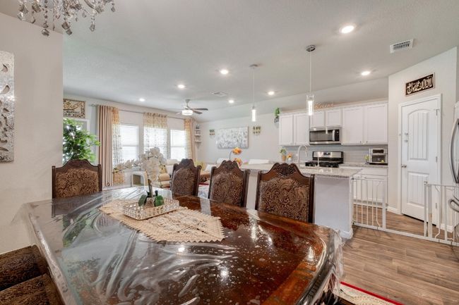 Dining area featuring a chandelier and recessed lighting | Image 10