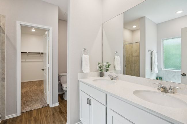 Dual sinks. Crisp and clean white cabinets with quartz counters. | Image 15