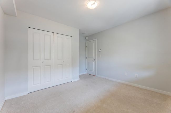 Unfurnished bedroom with light carpet and a closet | Image 31