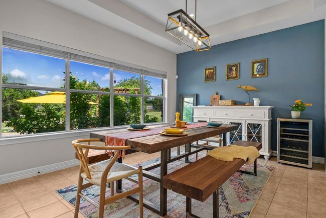 Spacious dining area with tray ceiling, updated light fixture & a lovely view | Image 13