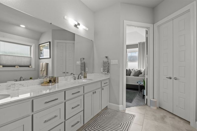Full bathroom featuring double vanity, a closet, ensuite bath, and tile patterned floors | Image 16
