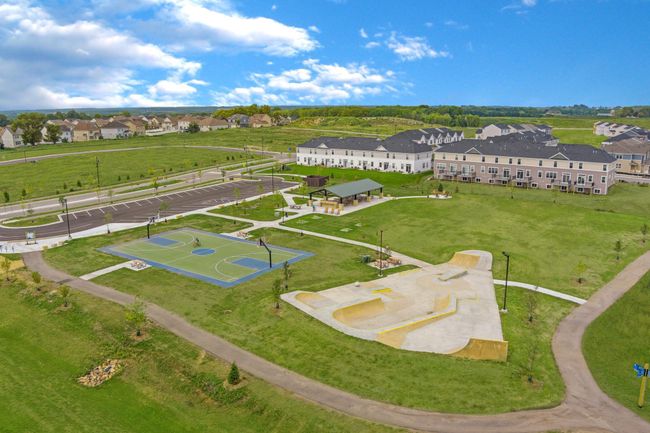 A vibrant community space at Timber Creek featuring a basketball court, skate park, covered picnic area, and open green spaces. | Image 29
