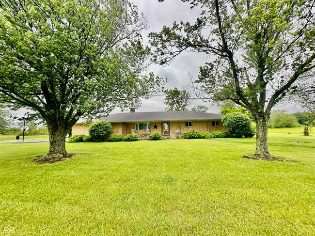 single story home with a front yard, brick siding, and a chimney | Image 6