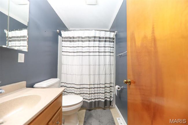 Full bath featuring toilet, vanity, ornamental molding, and a shower with shower curtain | Image 14