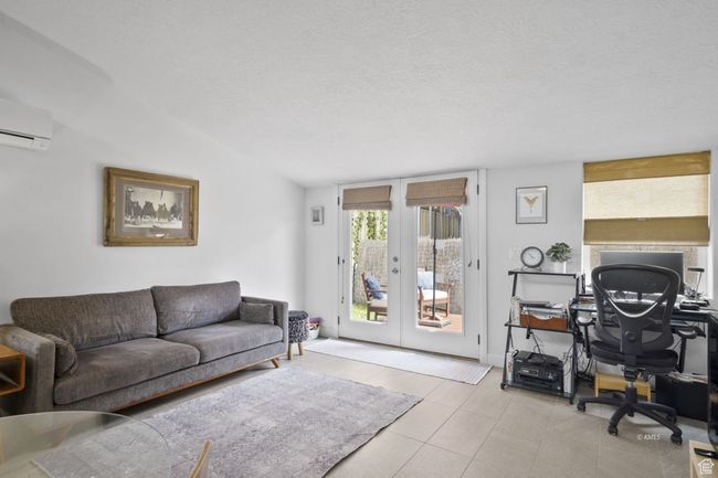 Living room with lofted ceiling, french doors, and a wall unit AC | Image 5